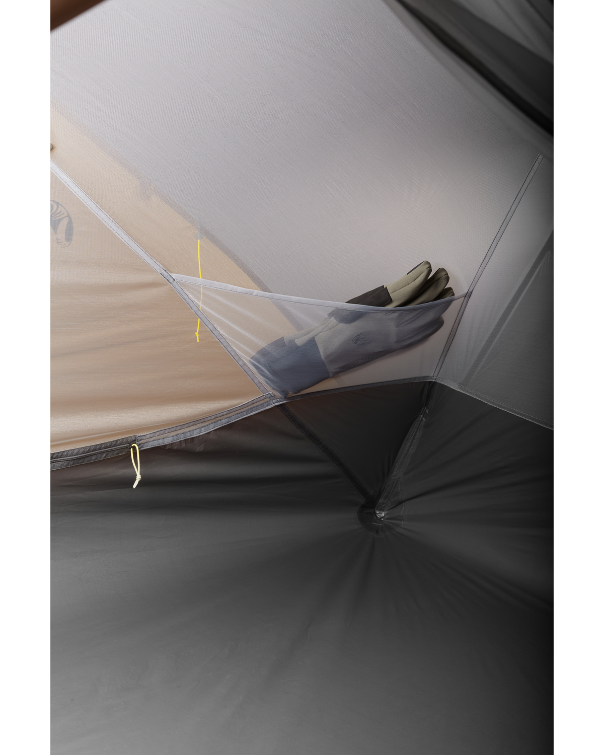 a pair of glove tucked inside internal storage pocket in the Mountain Star 2 Person Tent in Gunmetal Grey, Camel Brown
