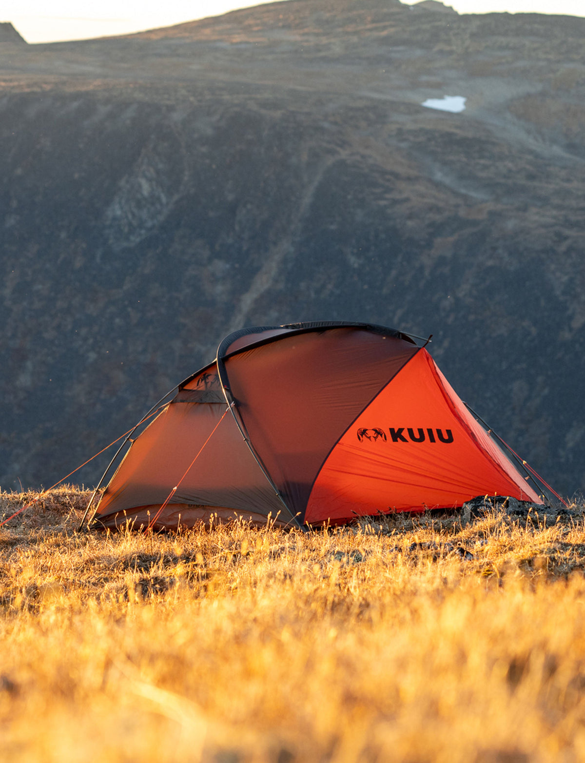Full the structured Mountain Star 2 Person Tent in Gunmetal Grey, Orange, with a beautiful mountain backdrop