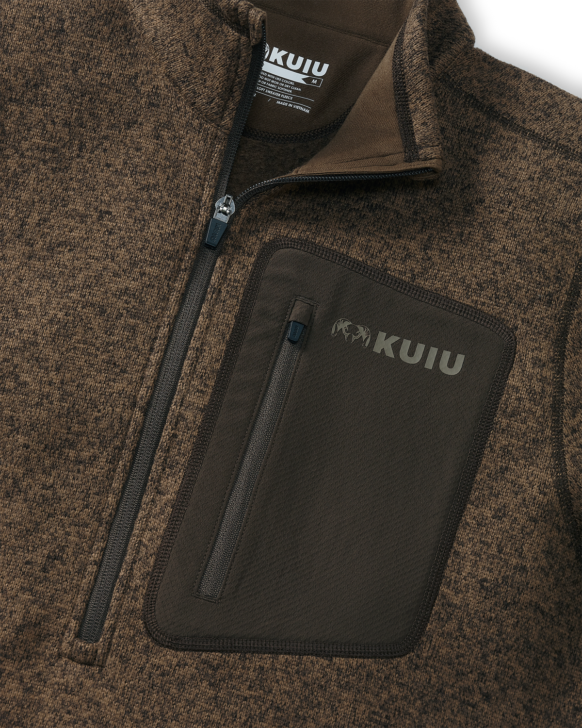 Close-up, Highlighting front zipper, tagless KUIU label, and front left chest pocket on Base Camp Pullover Sweater in Grizzly Brown Heather