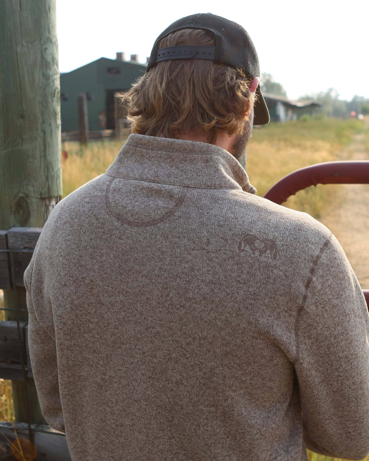 Back of Base Camp Pullover Sweater in Khaki Heather, highlighting embroidered KUIU Sheep logo on the right shoulder 