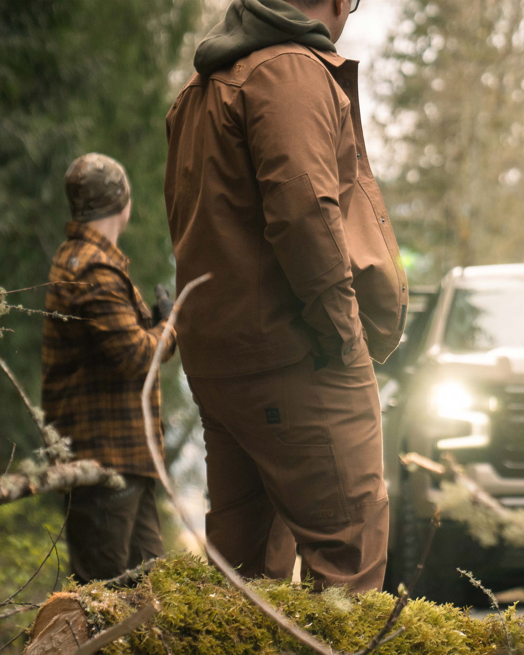 Man standing in an outdoor setting with his hand in his Brawley Pant pocket in Saddle Brown