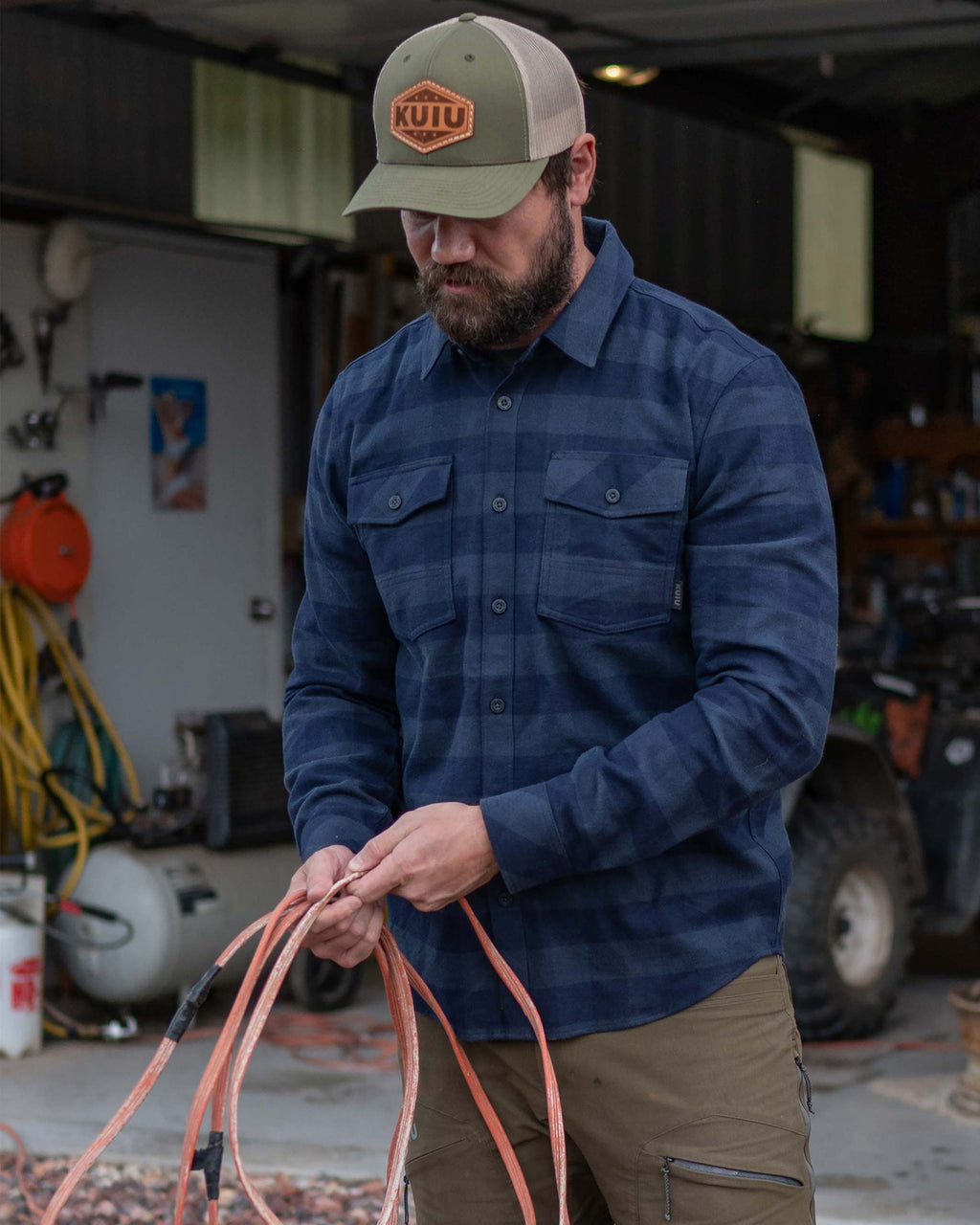 Man outside organizing cords wearing Field Flannel Shirt in Steel Blue Buffalo Check