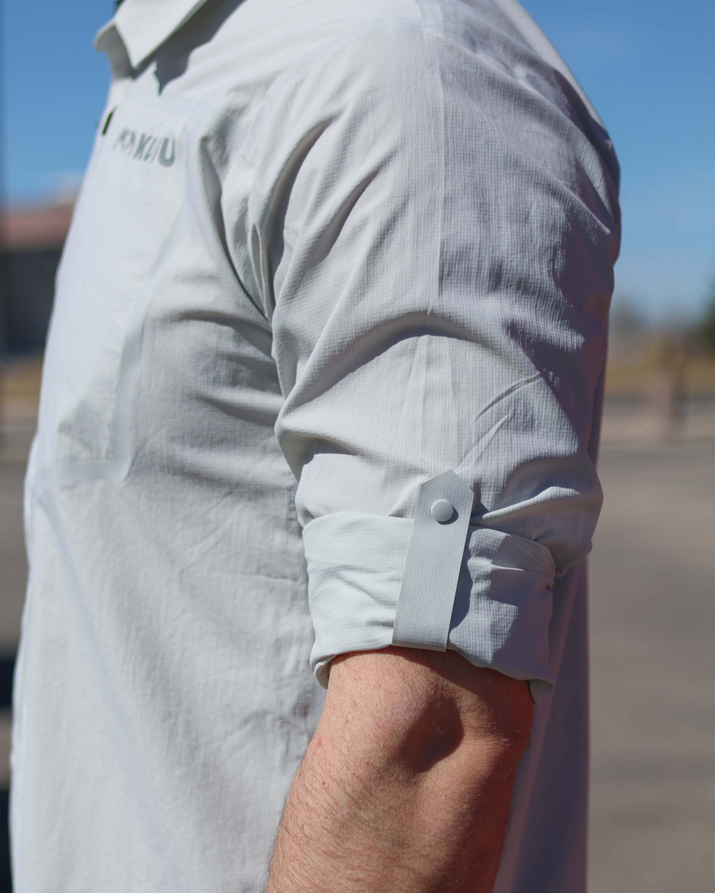 Close-up of rolled up sleeve and snap-closure tabs on the Salton Long Sleeve in Lunar Grey