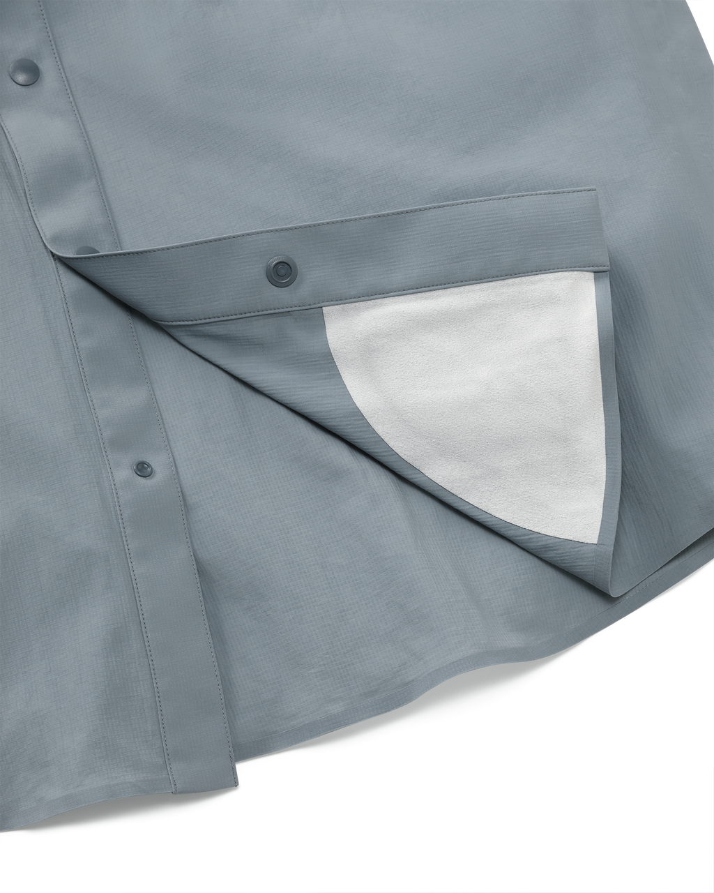 Detail view of integrated micro-fiber lens cleaning cloth patch sewn on the inside lower hem of the Salton Long Sleeve Shirt in Slate Grey