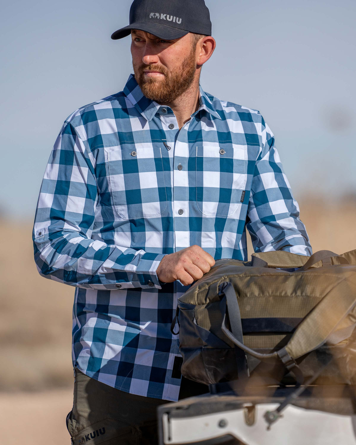 Hunter wearing Borrego LS Shirt in Blue Lake Plaid looking into the distance