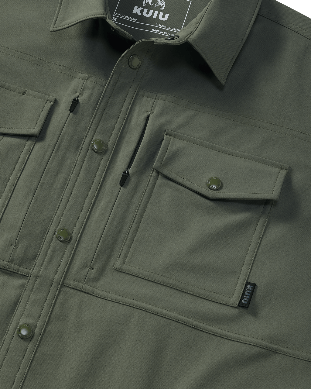 Close-up of chest pocket and vertical zipped pocket on Tour Shirt Jacket in Dark Sage
