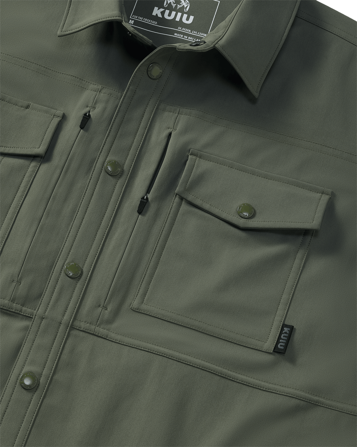 Close-up of chest pocket and vertical zipped pocket on Tour Shirt Jacket in Dark Sage