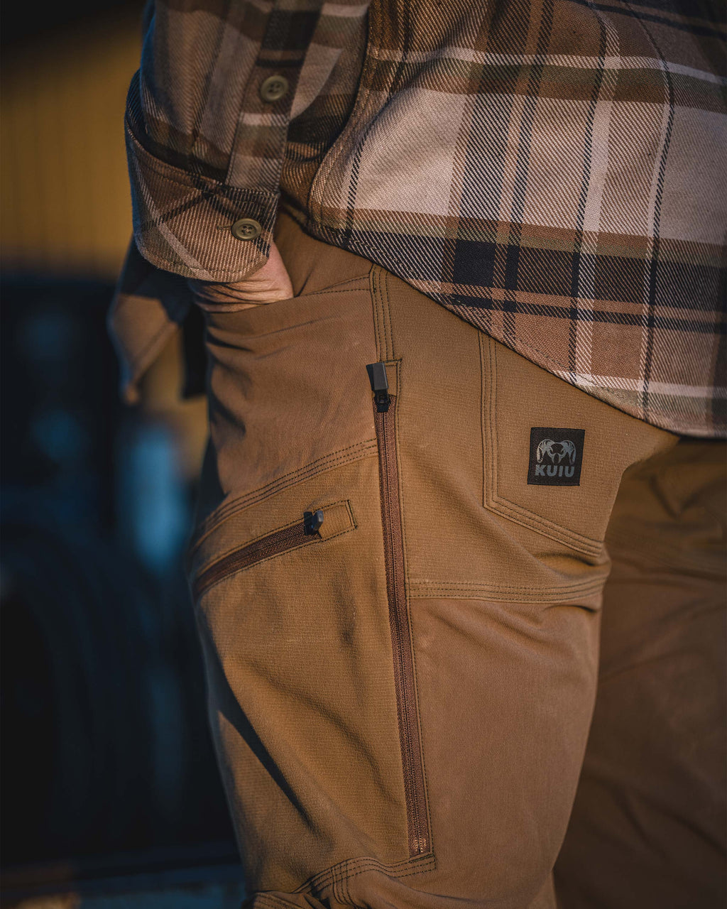 Side view of zippered hip vent on the Groundwork Stretch Woven Pant in Tobacco Brown