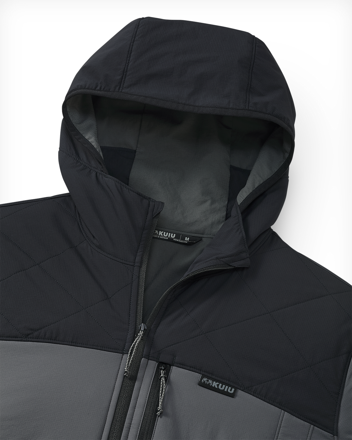 Close-up of the hood on a Transit Packable Jacket in Black/Gunmetal showing the quilted chest panel, zipper, and KUIU sewn-in label.