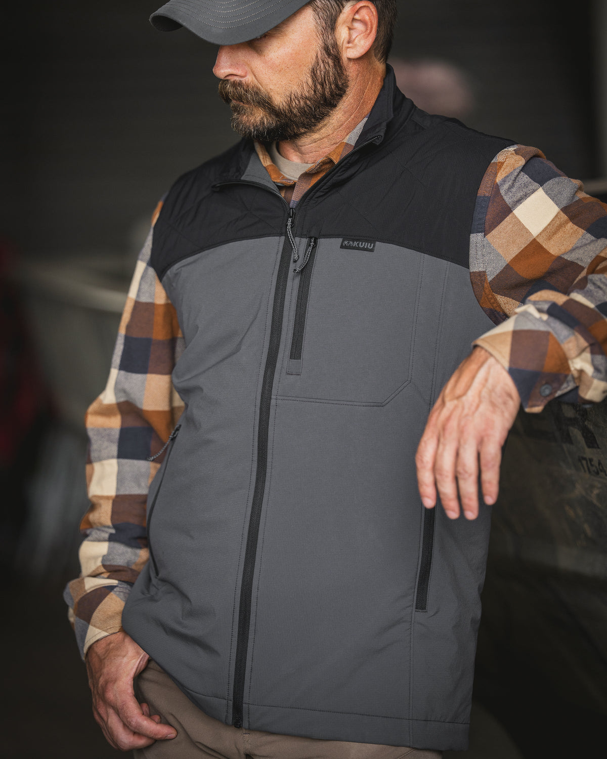 A man wearing a zipped Transit Packable Vest in Black/Gunmetal.