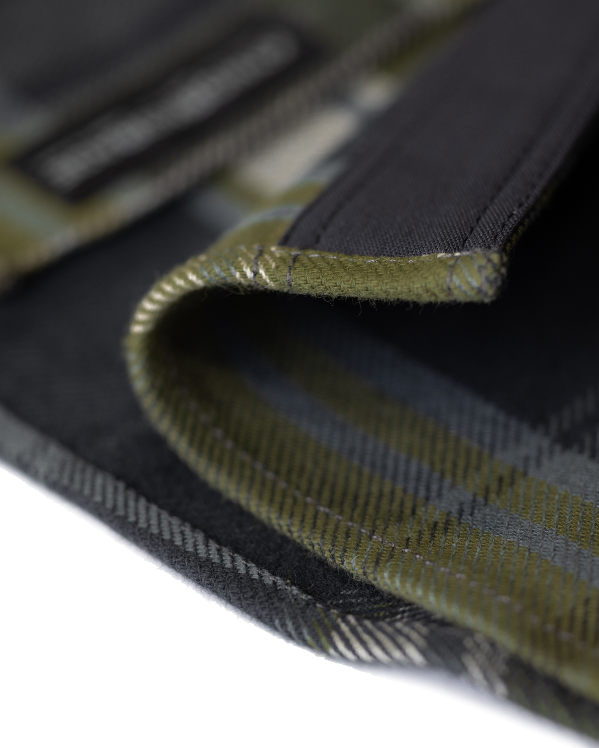 Close-up detail of durable stitching and texture of the fabric along the bottom corner heam on a Flannel Heavyweight Flannel in Verde Check Plaid