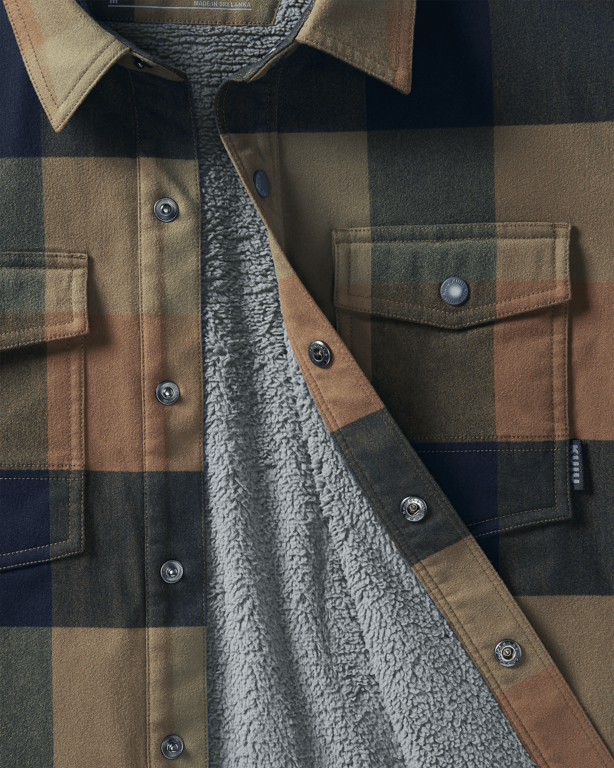 Detail image showing the interior fleece and snap-front buttons on Fleece Lined Flannel Shirt Jacket in Valo Plaid
