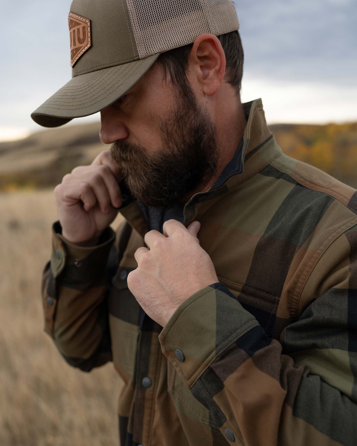 Hunter fixing the collar on his Field Flannel Shirt Jacket in Valo Plaid