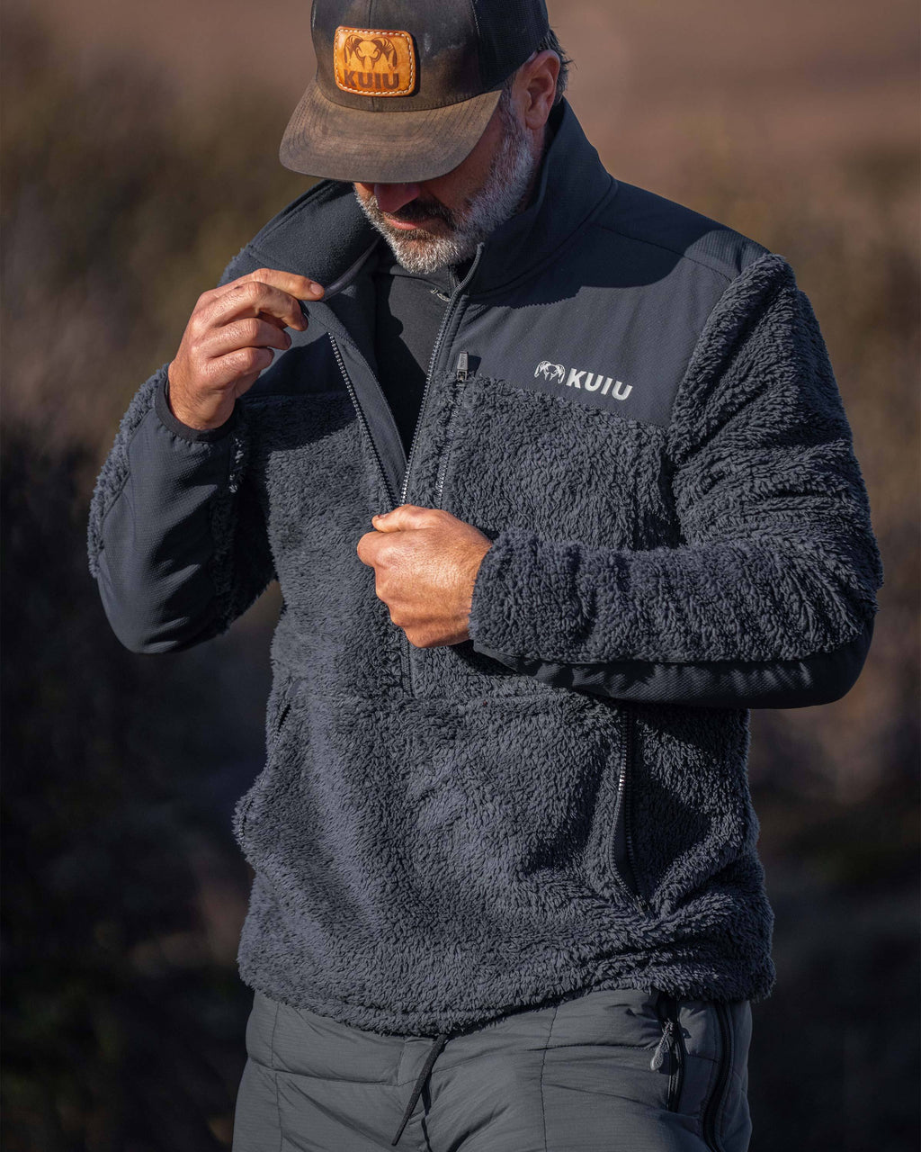 Hunter unzipping his Sherpa Fleece Zip Pullover in Nightfall Blue