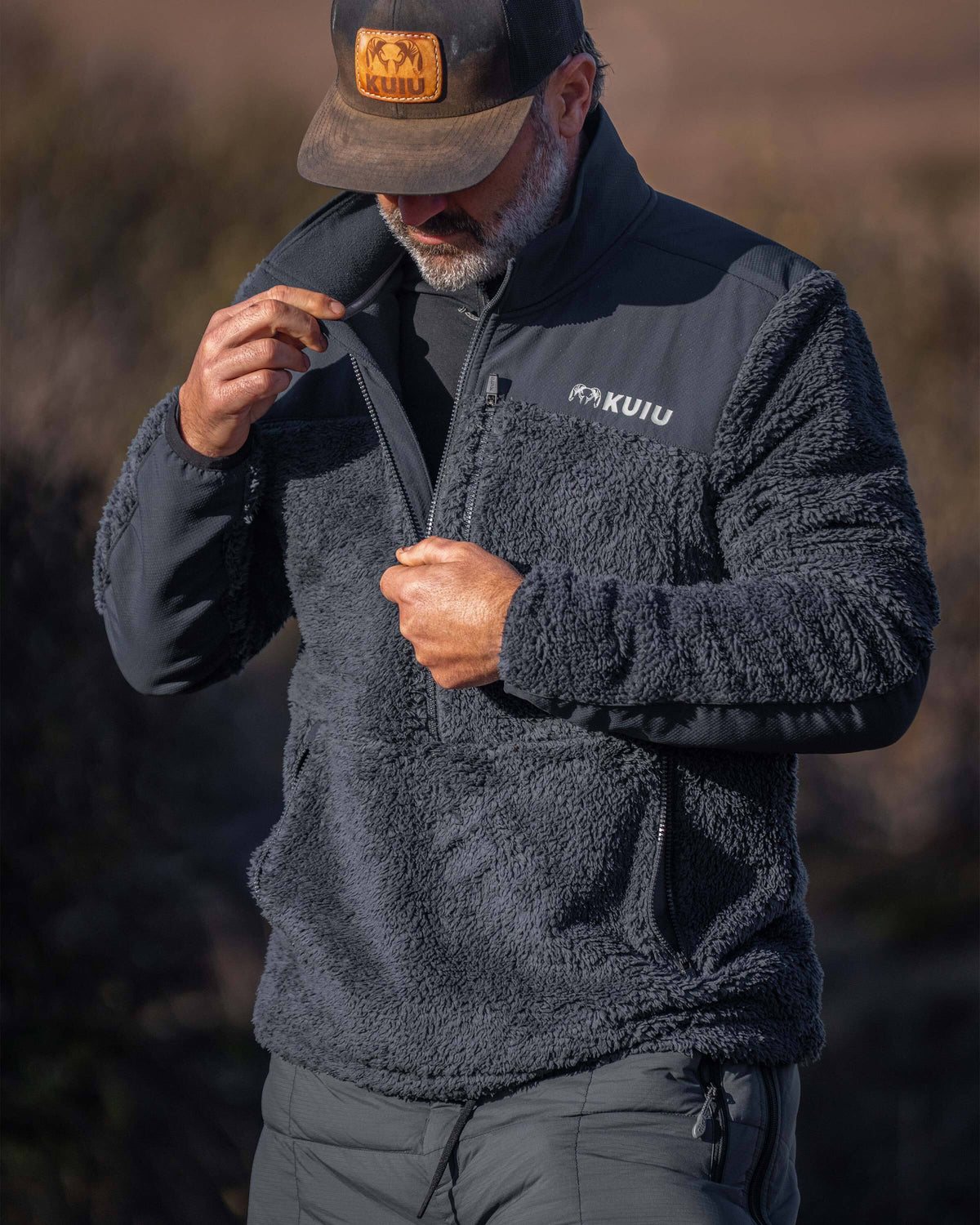 Hunter unzipping his Sherpa Fleece Zip Pullover in Nightfall Blue