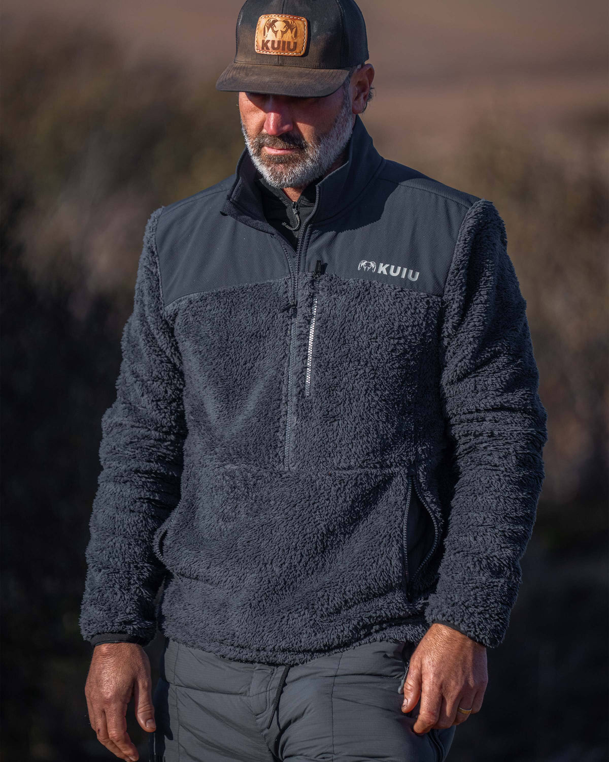 Hunter in an outdoor setting wearing Sherpa Fleece Zip Pullover in Nightfall Blue
