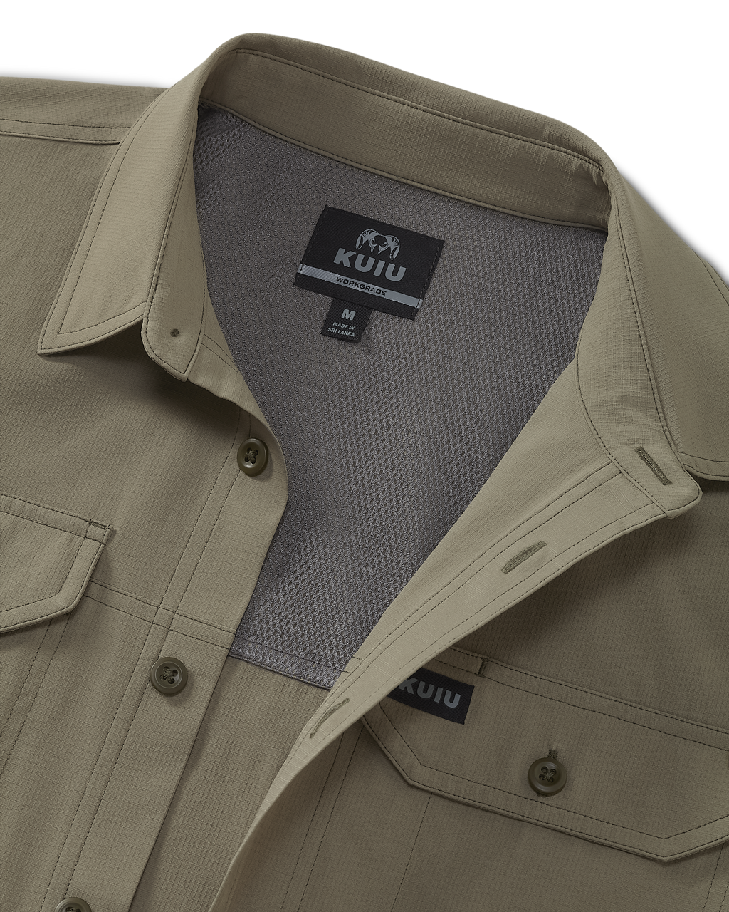 Close-up of button-up KUIU Short Sleeve Work Shirt, showing the collar, chest pocket, and interior mesh lining, with a visible KUIU Workgrade size tag at the neckline.