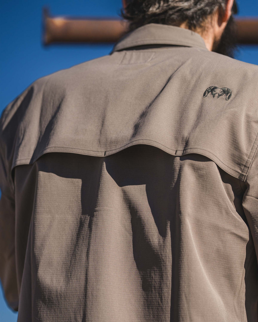 Close-up back view of Gauge Long Sleeve Work Shirt in Rodeo Brown, Highlighting back yoke venting with mesh liner for superior airflow.