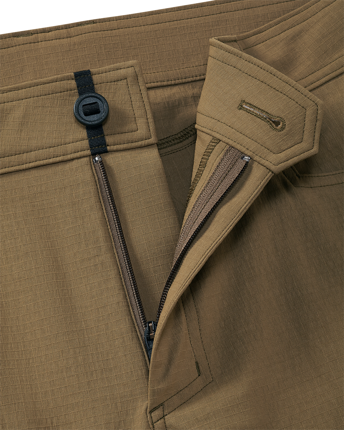 Close-up of open fly front zipper and button on Motive Workgrade Pant in Tobacco Brown