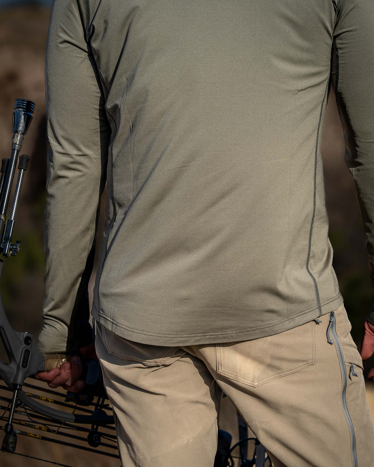 Back view of hunter wearing Vital S2 Zip-T  in Ash Color, showcasing its standard length and finished bottom hem.