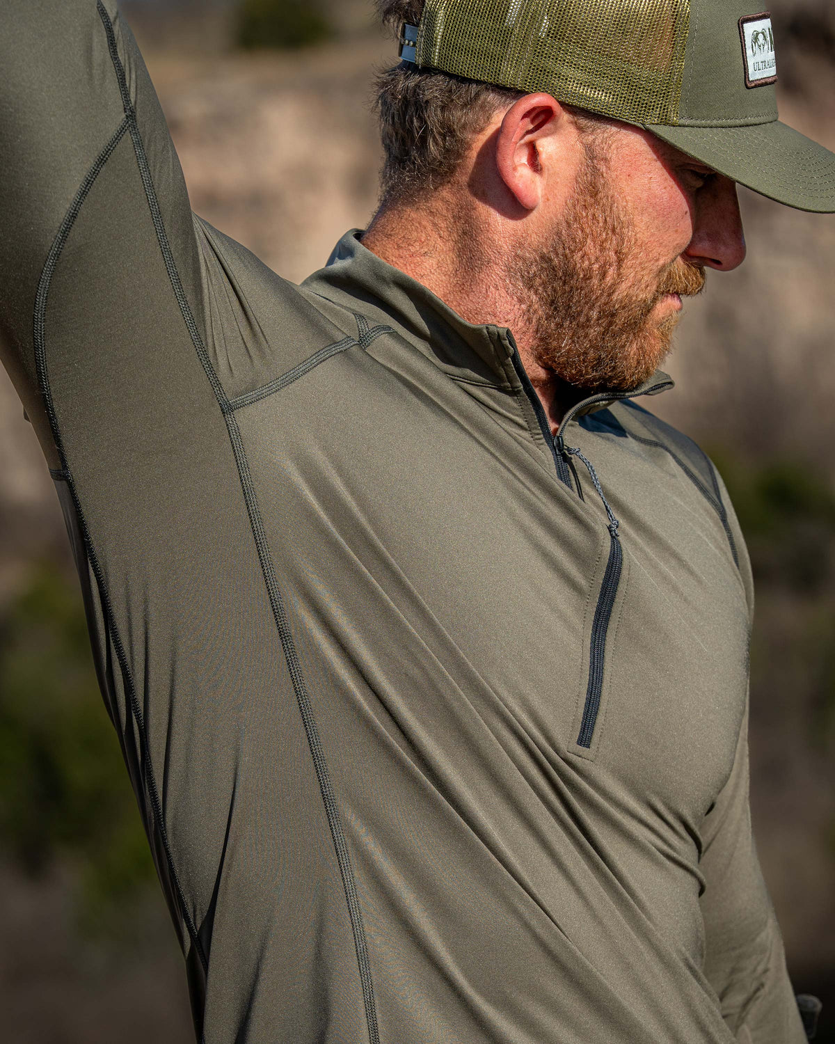 Hunter demonstrating full shoulder and arm mobility while wearing Vital S2 Zip-T in Ash Color.