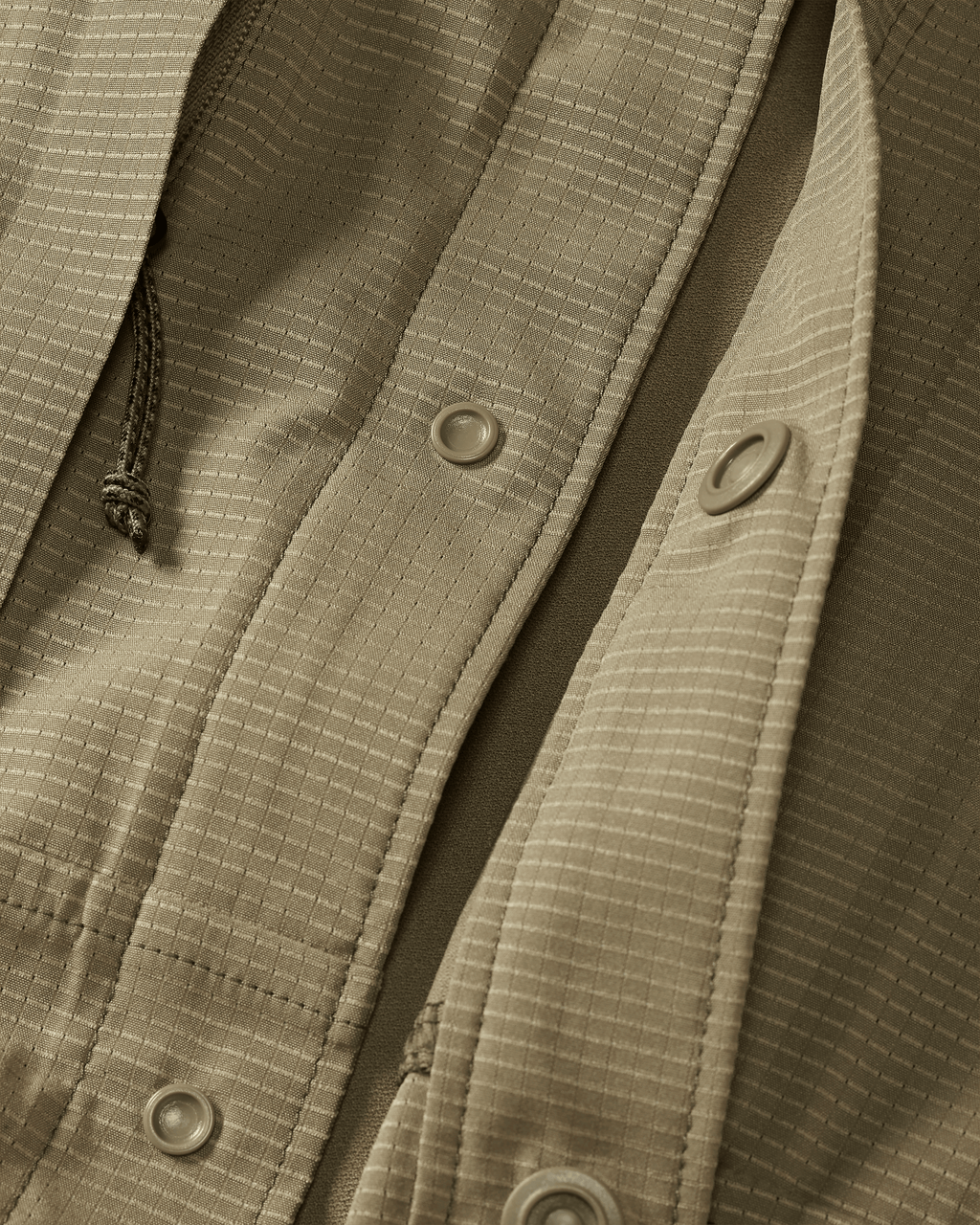 Front of unsnapped buttons on Tiburon Hybrid Snap Shirt in Khaki