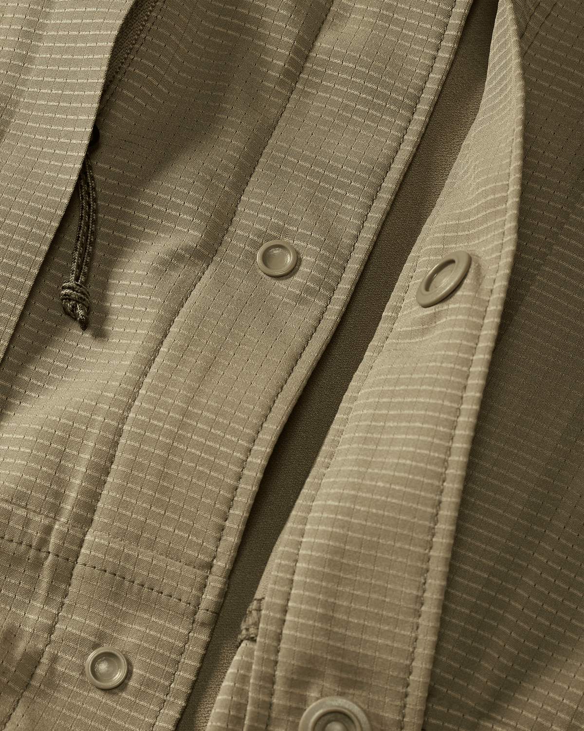 Front of unsnapped buttons on Tiburon Hybrid Snap Shirt in Khaki