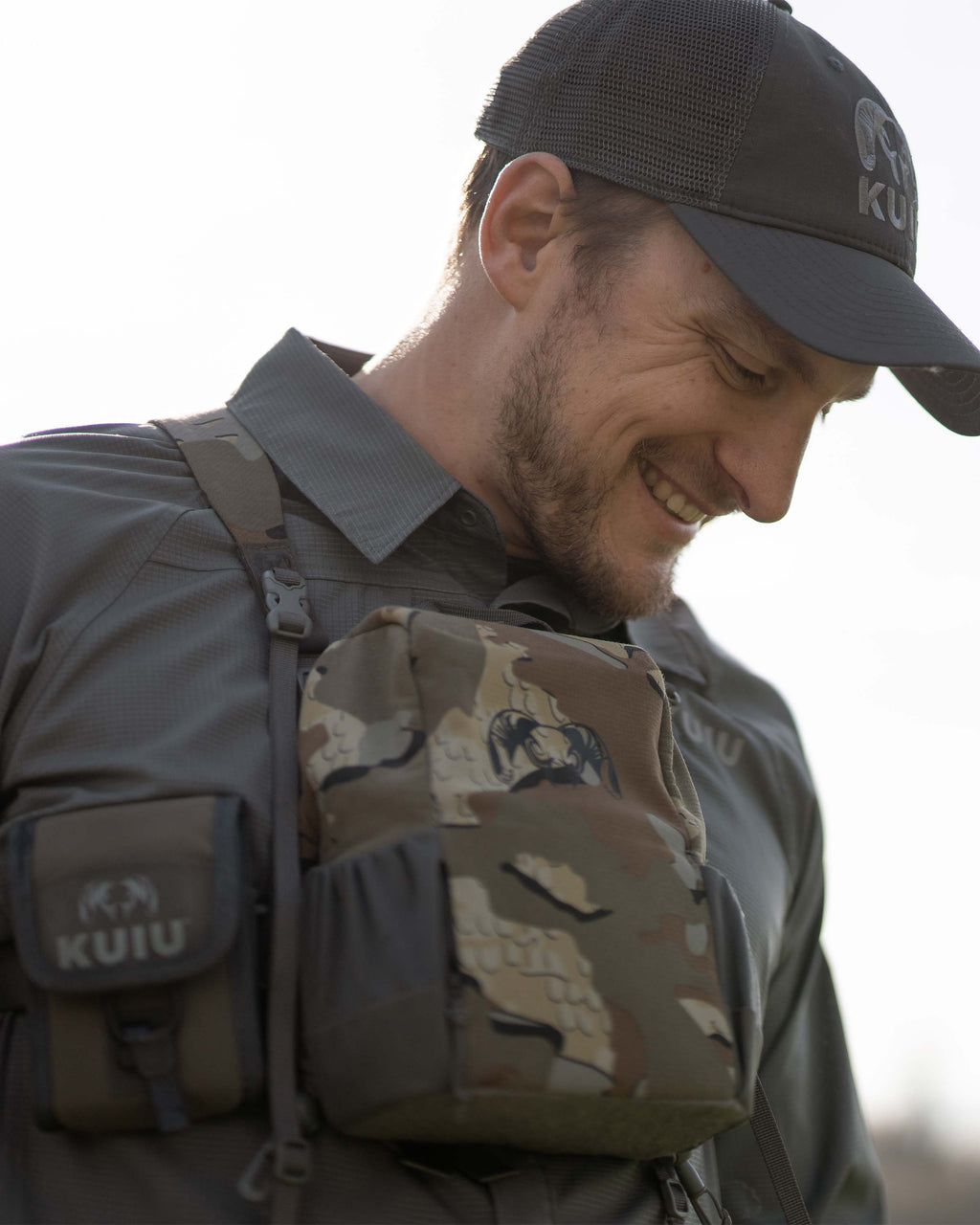 Hunter smiling, carrying a PRO Bino Harness on his chest, wearing Tiburon Hybrid Snap Shirt in Stone Grey