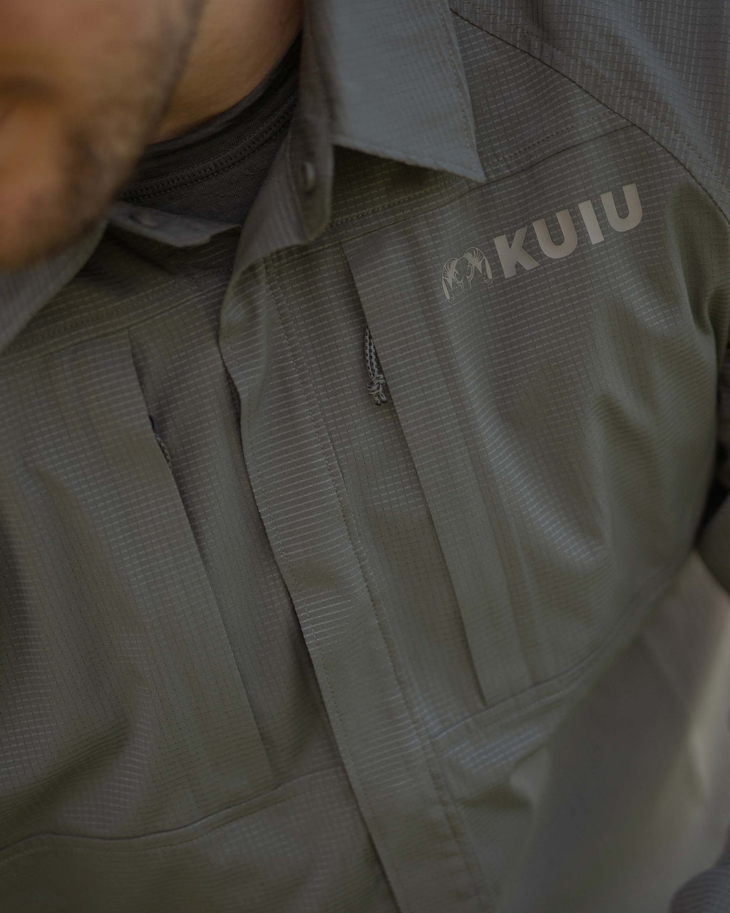 zipped chest pocket on Tiburon Hybrid Snap Shirt in Stone Grey shown on Hunter