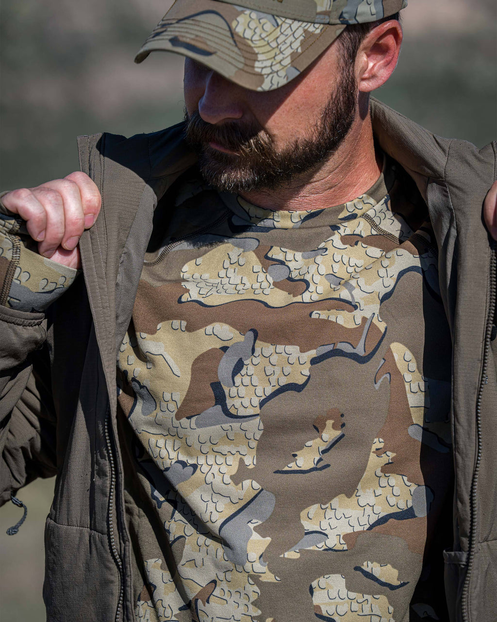 A man wearing a Vital S3 Long Sleeve Crew in Valo Camouflage, focusing on the front chest.