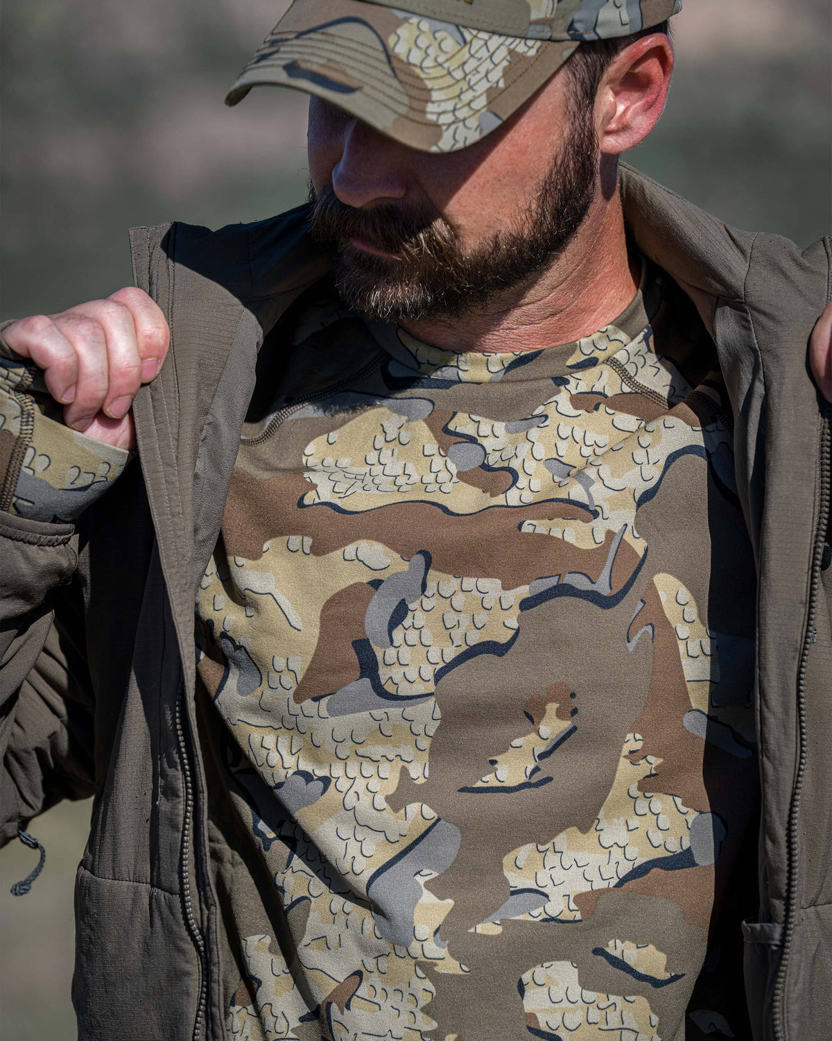 A man wearing a Vital S3 Long Sleeve Crew in Valo Camouflage, focusing on the front chest.