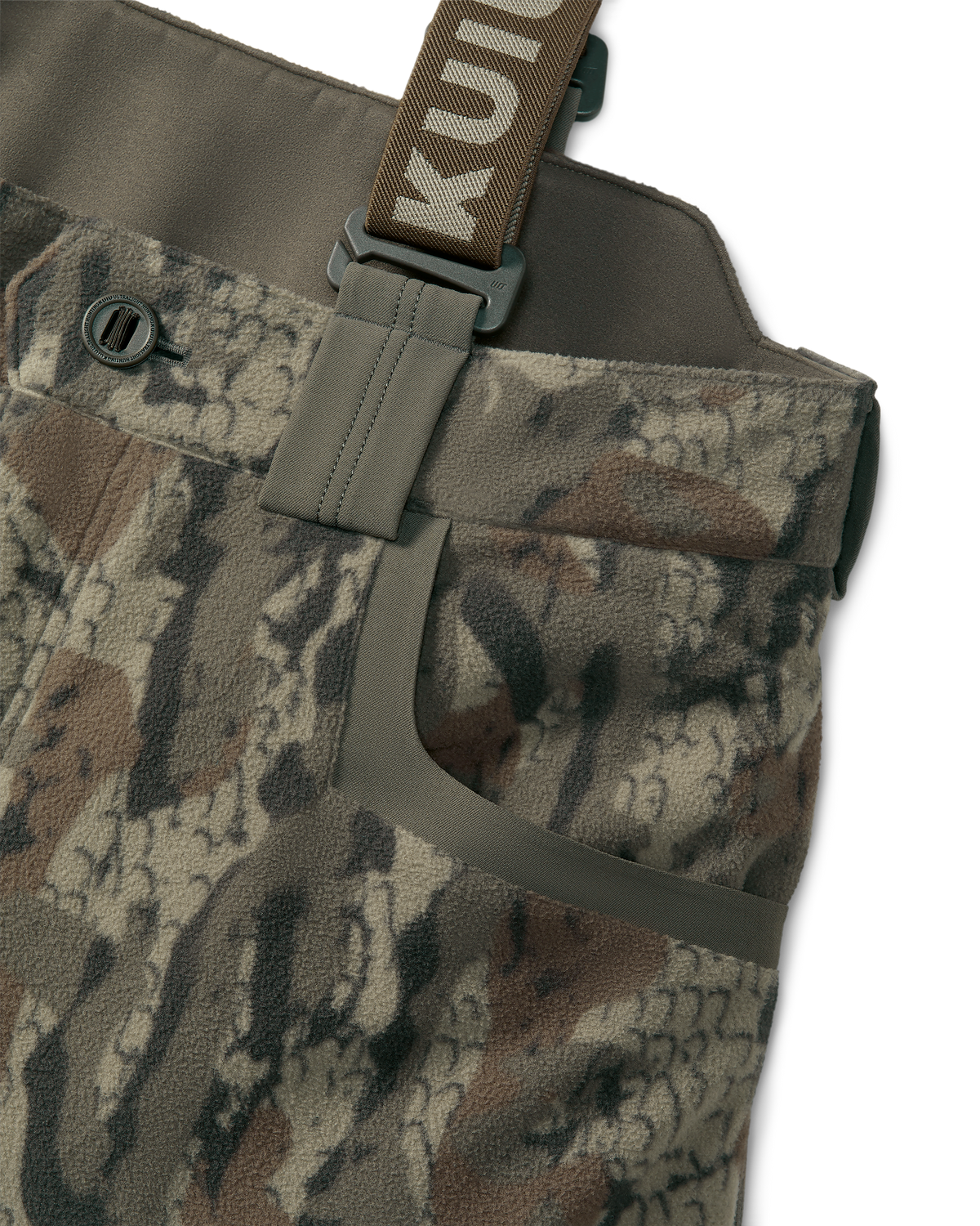 Proximity Insulated Pant in Veros Camouflage featuring fully adjustable removable suspenders and open hand pockets detail callout