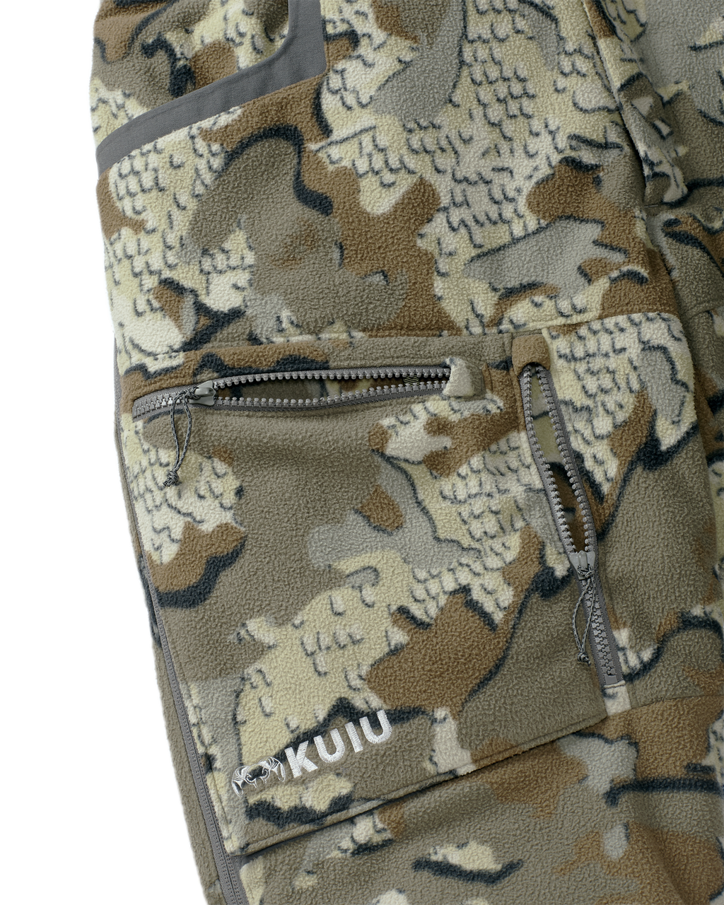 Close-up view of front zippered dual-compartment cargo pockets on the Proximity Insulated Pant in Valo Off-Shade