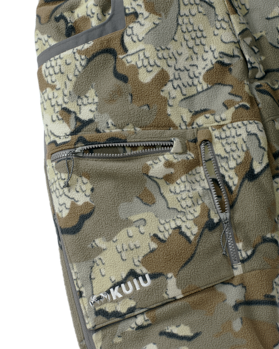Close-up view of front zippered dual-compartment cargo pockets on the Proximity Insulated Pant in Valo Off-Shade