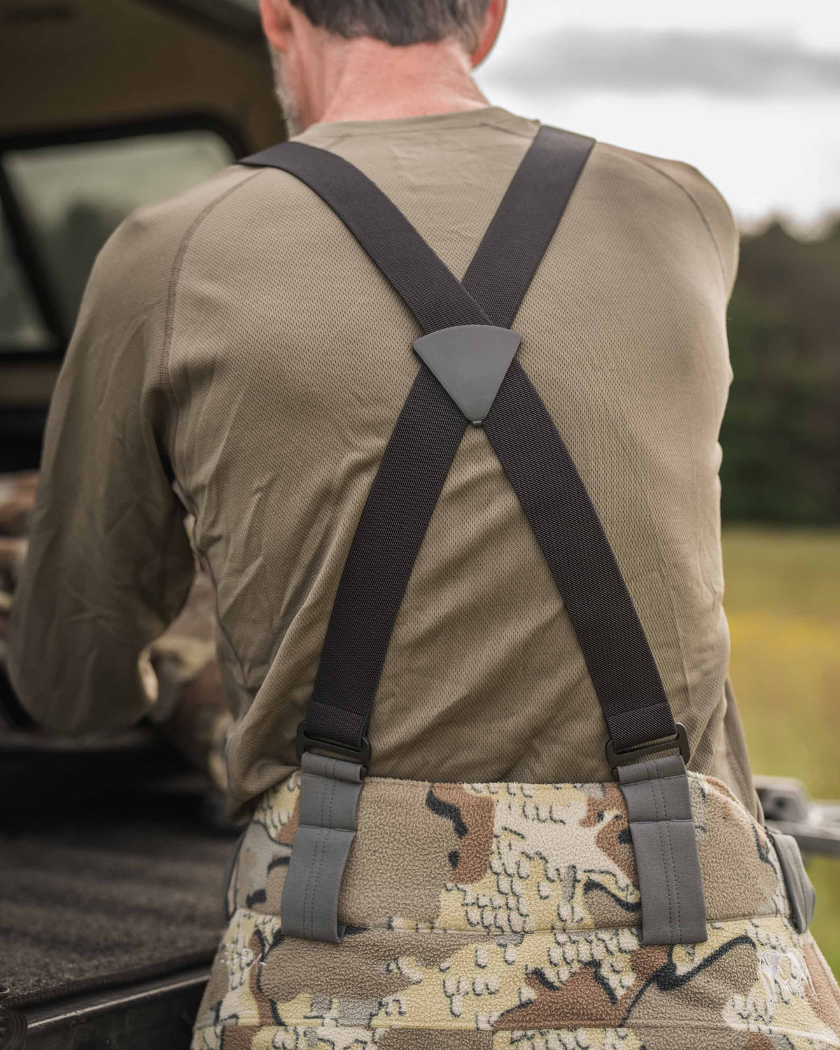 Back of Hunter Wearing Proximity Insulated Pants in Vias Off-Shade Camouflage Highlighting Removable Suspenders