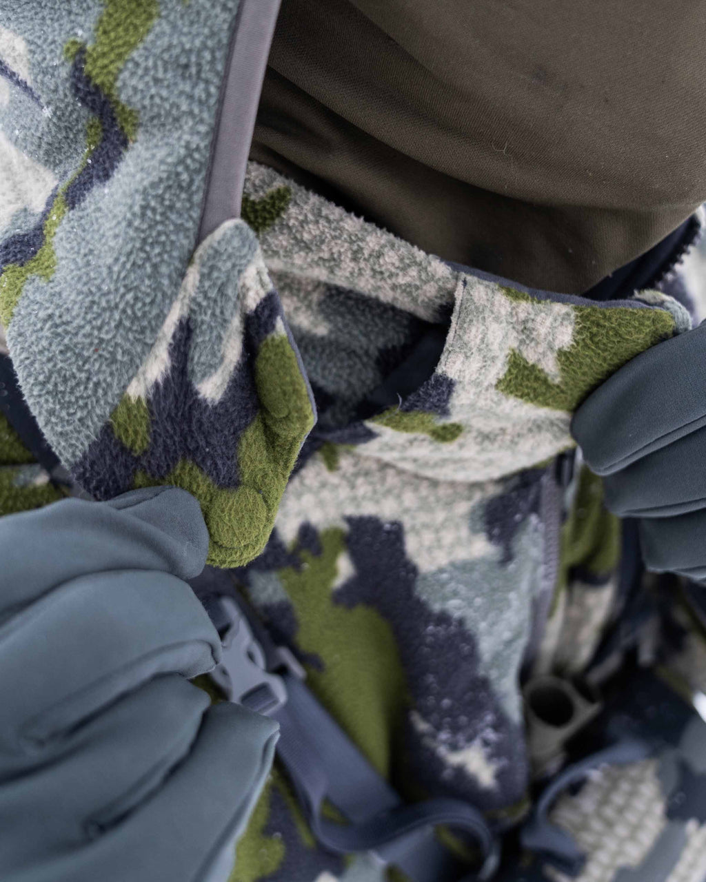 Front of Hunter Wearing Proximity Hooded Insulated Jacket in Verde Camouflage Highlighting Zip-off hood with magnetic connection points