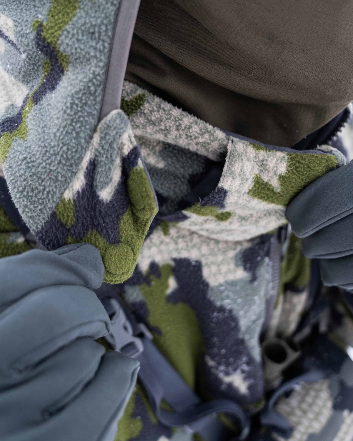 Front of Hunter Wearing Proximity Hooded Insulated Jacket in Verde Camouflage Highlighting Zip-off hood with magnetic connection points