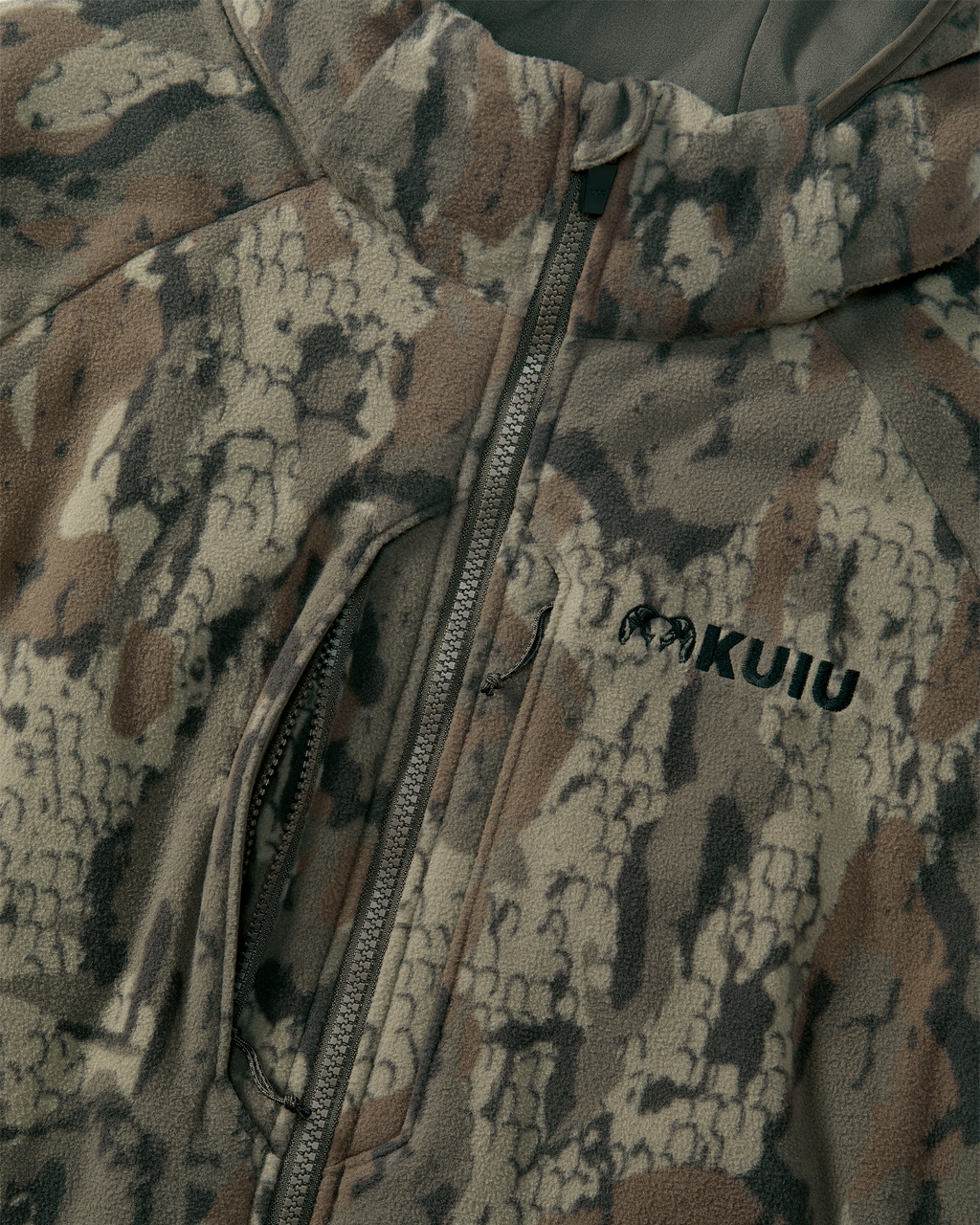 Close-up of front zipper and chest vertical pockets of the Proximity Hooded Insulated Jacket in Veros Camouflage.