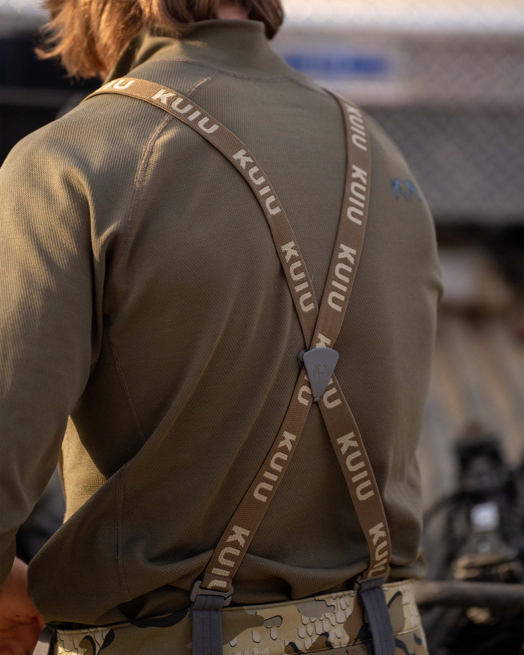 Back of hunter wearing Encounter Pant in Valo Camouflage showing suspender detail