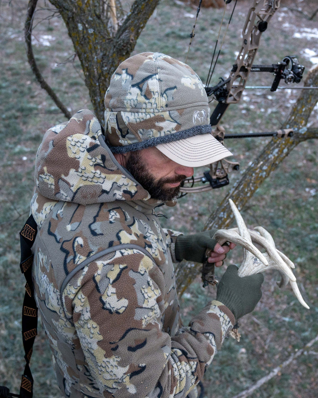 Top view of hunter in treestand wearing Proximity Beanie in Valo Camouflage over hat