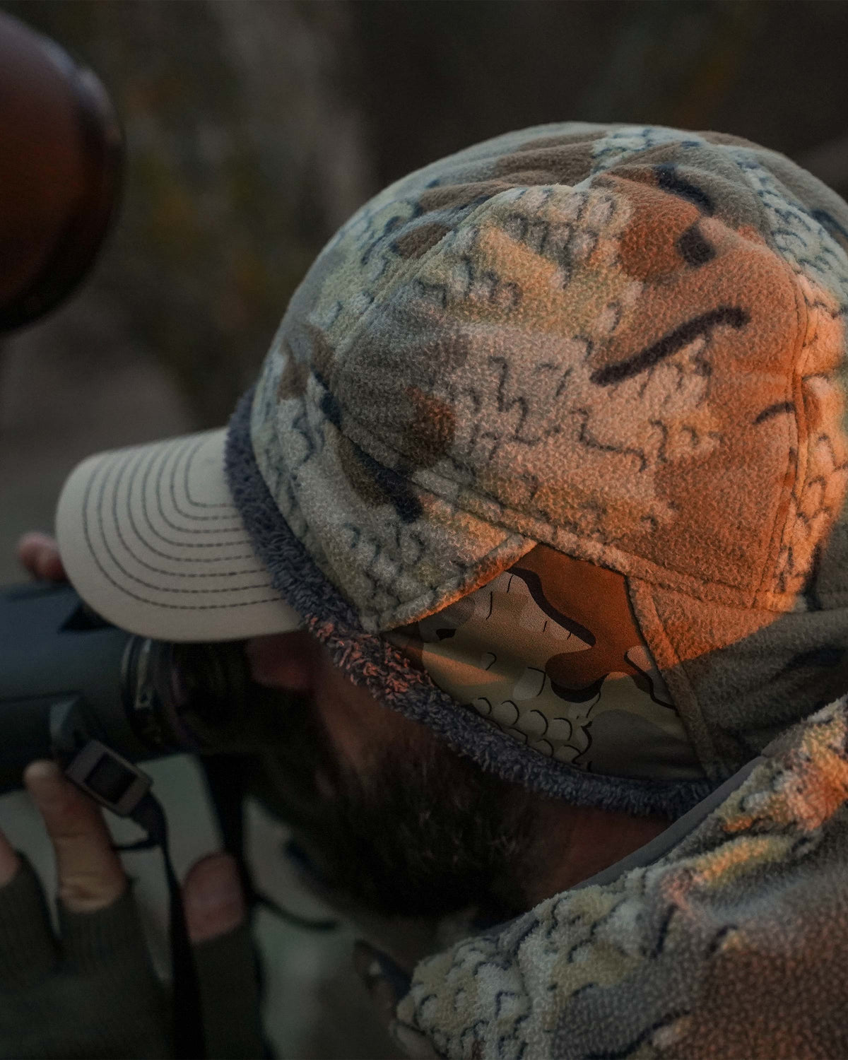 hunter glassing wearing Proximity Beanie in Valo Camouflage over hat