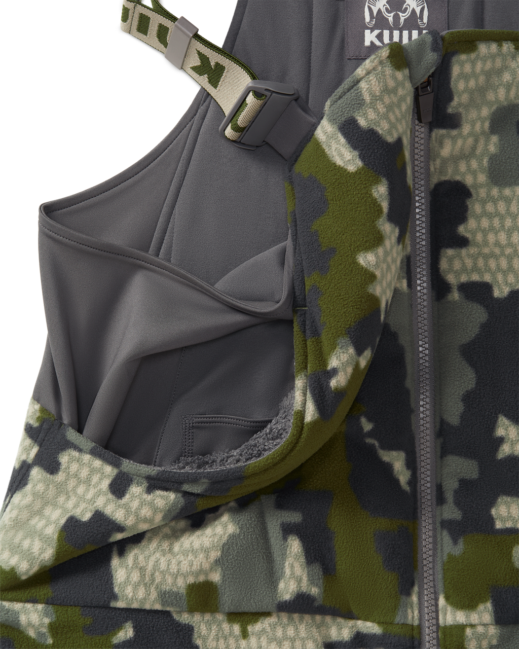 Close-up of a KUIU Proximity Insulated Bib in Verde camouflage highlighting sherpa fleece-lined upper hand warmer pockets.