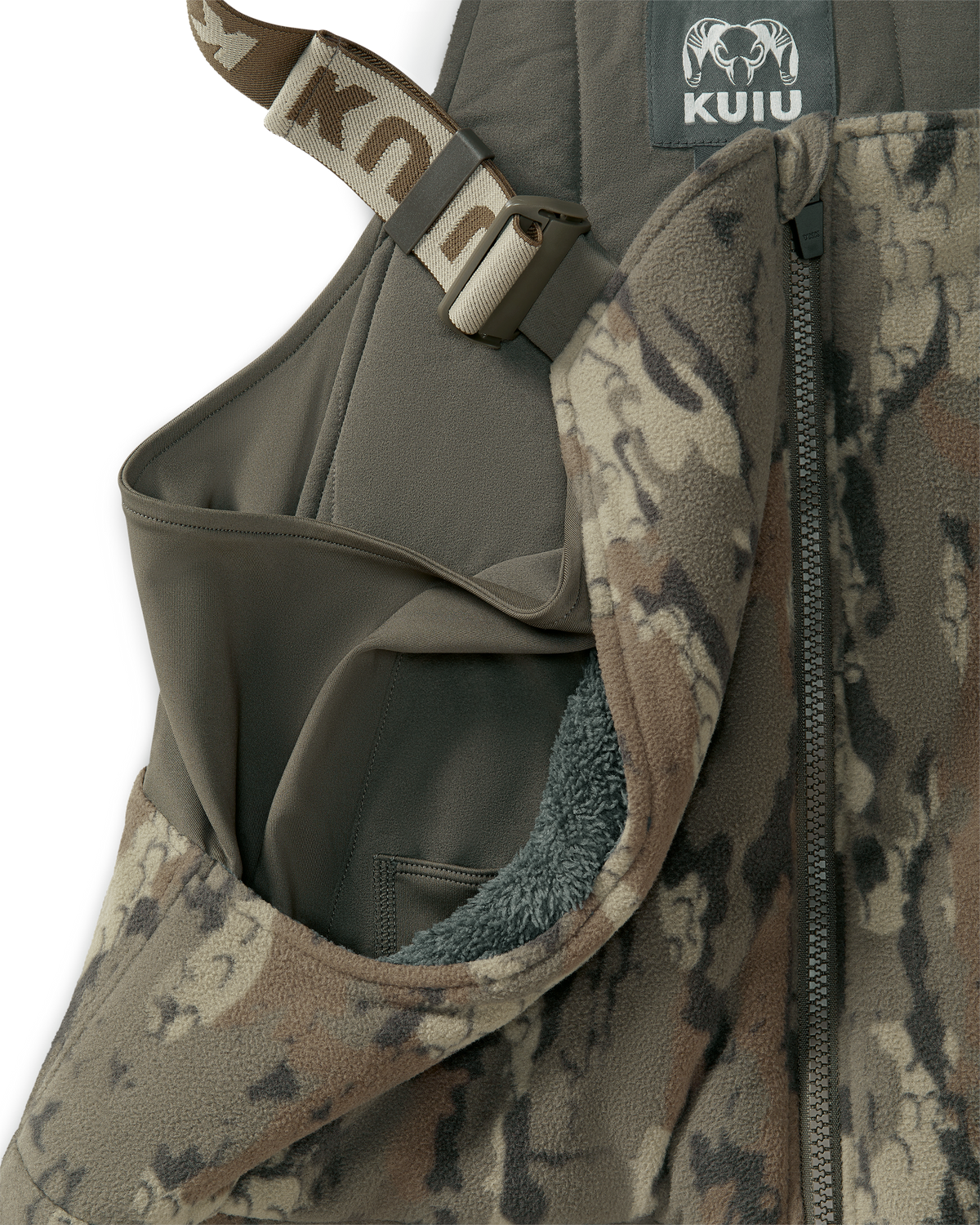 Close-up of a KUIU Proximity Insulated Bib in Veros camouflage highlighting sherpa fleece-lined upper hand warmer pockets.