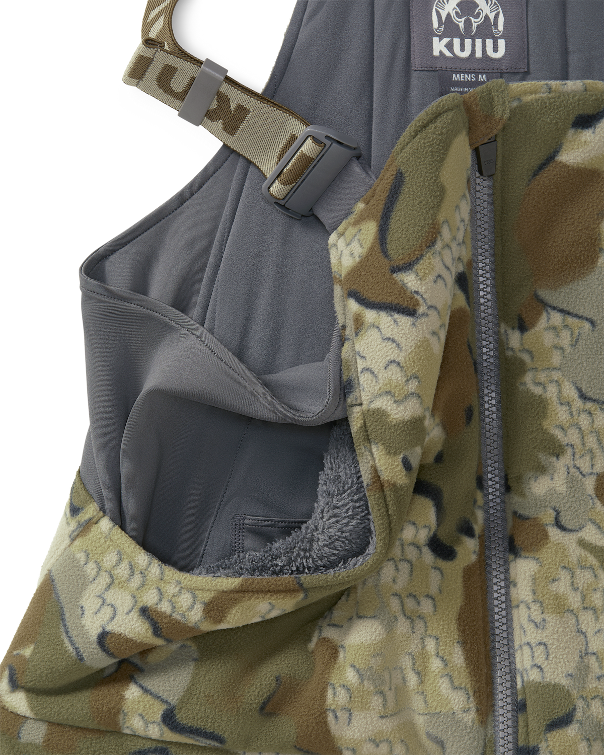 Close-up of a KUIU Proximity Insulated Bib in Valo camouflage highlighting sherpa fleece-lined upper hand warmer pockets.