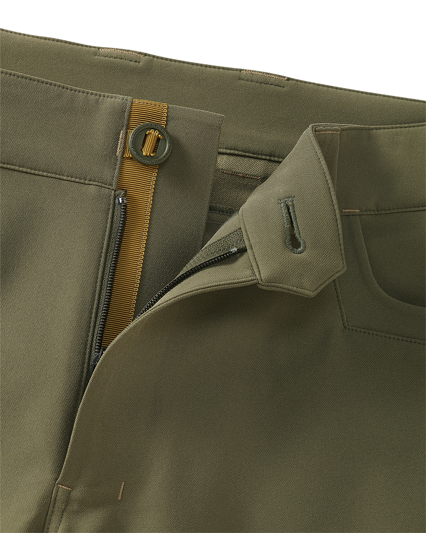 Close-up of open fly front zipper and button on the Attack Pant in Evergreen.