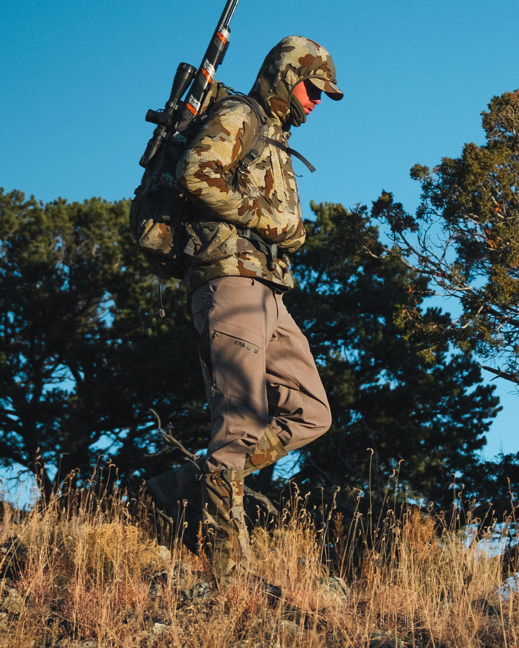 Side of Hunter Hiking Wearing Attack Pants in Khaki Color