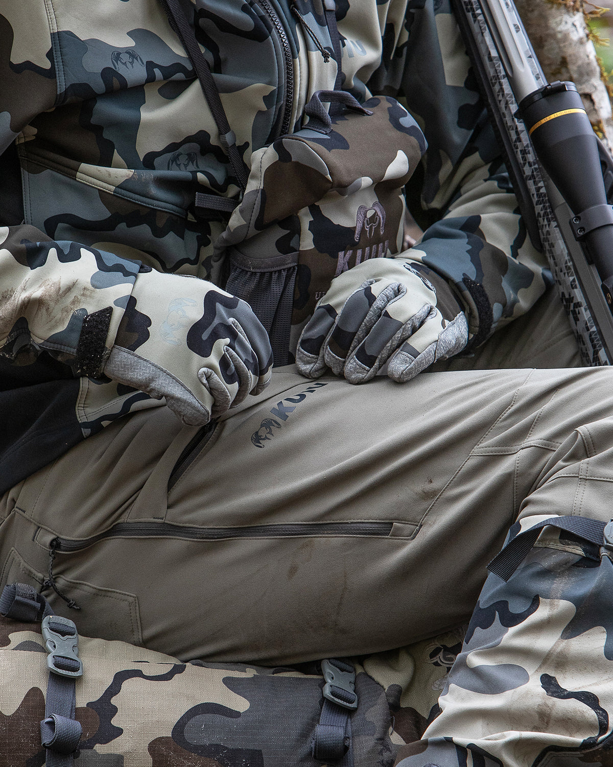Front, Angled View of Hunter Wearing Attack Pants in Khaki Color Highlighting YKK Zippered Cargo Pocket and Hip Vent