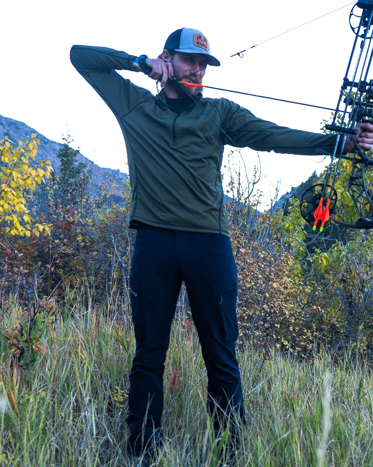Front of Hunter with Drawn Bow Wearing Attack Pants in Navy Blue Color