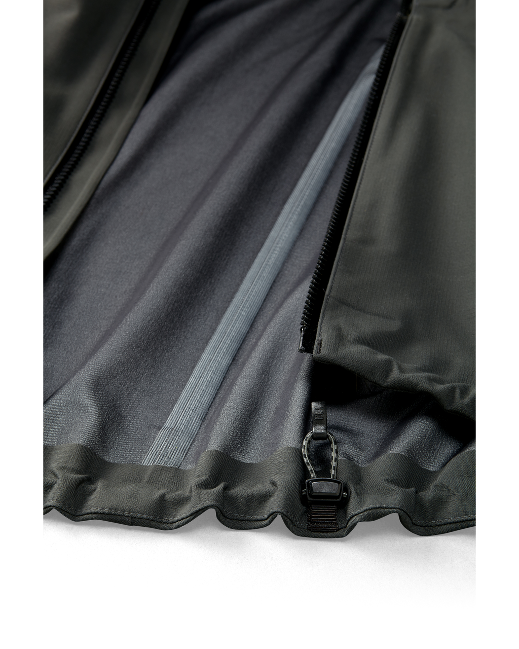 Kutana Storm Shell Jacket in Gunmetal Color showcasing the zipper and seam tape