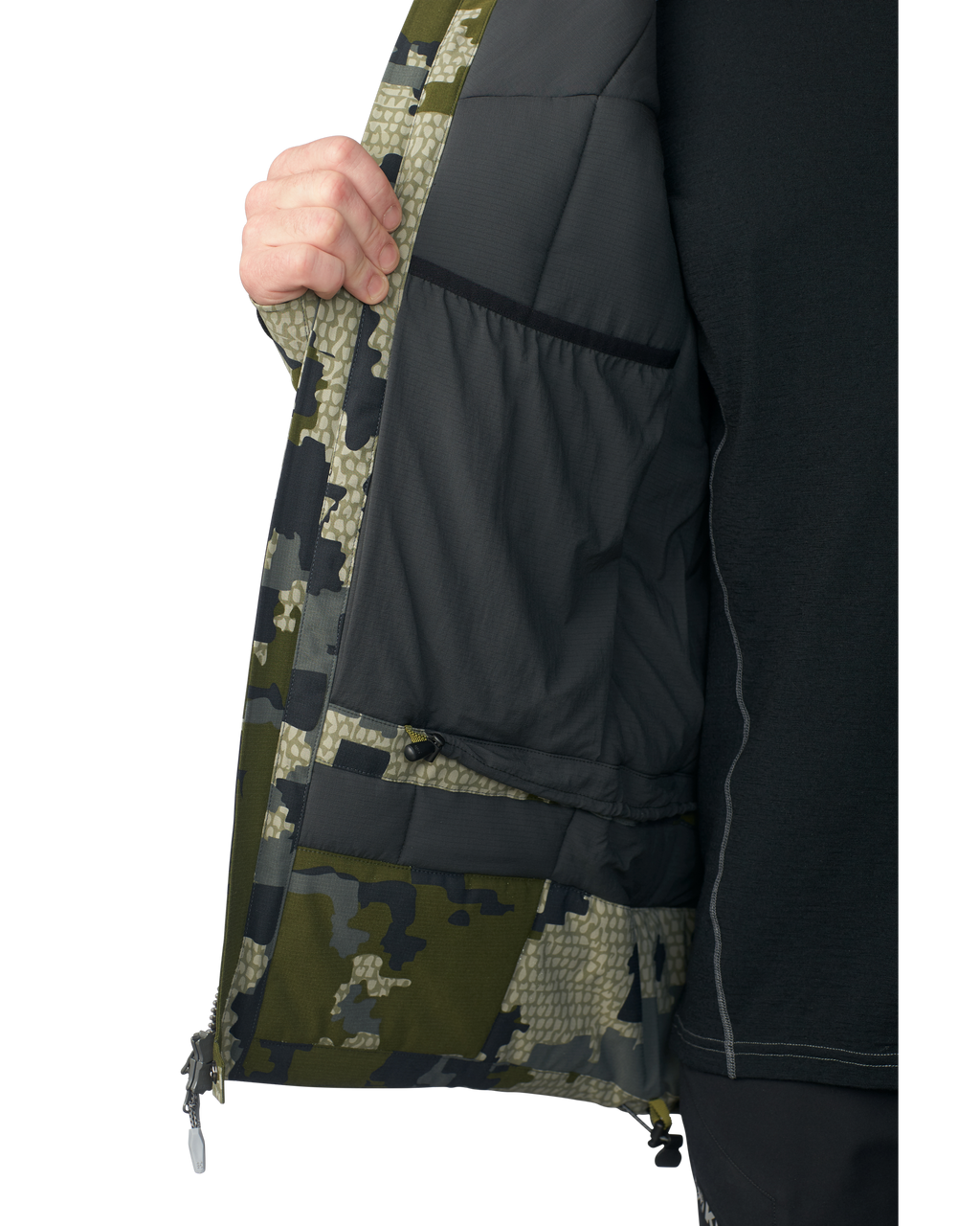 Hunter wearing the Kutana Gale Force Hooded Jacket in Verde Camouflage with their arm up showcasing the pit zip
